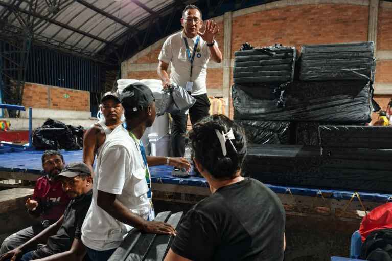 El equipo de Acción contra el Hambre distribuye kits familiares de alojamiento entre las personas acogidas temporalmente en el Coliseo de Quibdó, habilitado como albergue tras el terremoto, el 12 de agosto de 2026. © Acción contra el Hambre.